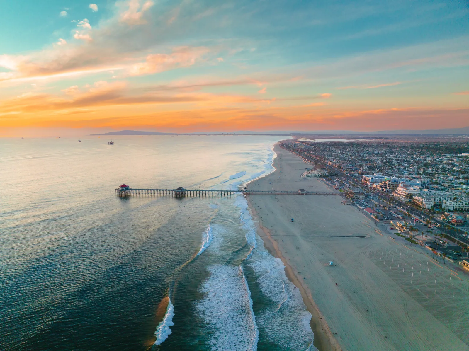 Huntington Beach pier and coastline at sunset